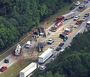 Authorities render assistance to injured people on an overturned church bus. (WSB-TV via AP)