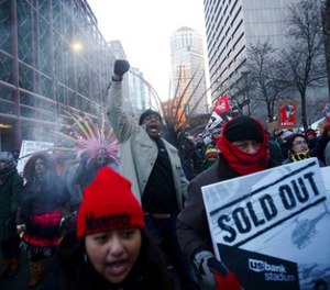 Protester James Franklin, center, of the NAACP yells en route to U.S. Bank Stadium, where an Anti-Racist Anti-Corporate rally joined with Take a Knee Nation, in Minneapolis on Sunday, Feb. 4, 2018.