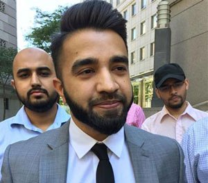 New York Police Department Officer Masood Syed, a practicing Muslim, center, leaves Manhattan federal court in New York Wednesday, June 22, 2016.