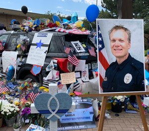 An Arvada police cruiser is adorned with messages in mourning of Officer Gordon Beesley. Beesley was fatally shot in ambush on June 21, 2021.