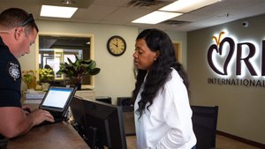 Behavioral health technician Ashanta Pleasant helps Peoria Police Department Officer Kevin Moe file paperwork for an involuntary admission at behavioral health center RI International in Peoria. Image: Mark Henle/The Arizona Republic