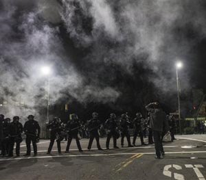 Demonstrators toss out smoke bombs during a march in Berkeley, California on Saturday, Dec. 6, 2014. (AP Image)