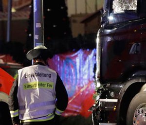 A firefighter walks past a star after a truck ran into crowded Christmas market in Berlin, Germany, Monday, Dec. 19, 2016, killing several people.