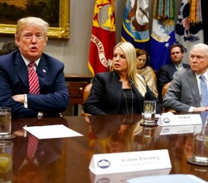 Florida Attorney General Pam Bondi, center, and Attorney General Jeff Sessions, right, look on as President Donald Trump speaks during a meeting with state and local officials to discuss school safety, in the Roosevelt Room of the White House, Thursday, Feb. 22, 2018, in Washington.
