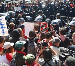 Protesters confront San Francisco Police officers outside of Alamo Square Park in San Francisco, Saturday, Aug. 26, 2017. Officials took steps to prevent violence ahead of a planned news conference by a right-wing group.