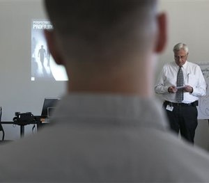 In this Feb. 11, 2015, photo, veteran LAPD officers Anne Bozzi, left, and Don Wynne, far right, instruct dozens of unidentified Los Angeles Police Department officers.