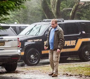 A security official stands at the end of the driveway leading to Vice President Joe Biden's home Sunday, Jan. 18.