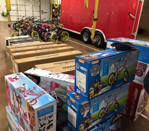 Volunteers including first responders worked to unpack and assembles children's bicycles at the Jerusalem Township Fire Hall over the weekend. The bikes will be donated as Christmas gifts to children under the care of Lucas County Children's Services. (Photo/Lucas County Children's Services Facebook)