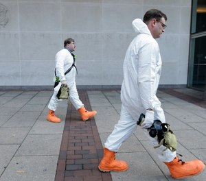 Firefighters in protective clothing prepare to enter the U.S. Courthouse in Philadelphia Wednesday, Feb. 20, 2013. The second floor of the federal court building was evacuated after authorities found a letter containing a threat about anthrax.