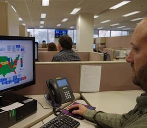 In this Nov. 18, 2014, photo, a researcher simulates a check done for the National Instant Criminal Background Check System or NICS, at the FBI’s criminal justice center in Bridgeport, W.Va. NICS did about 58,000 checks on a typical day in 2013. That surged to 145,000 on Black Friday.