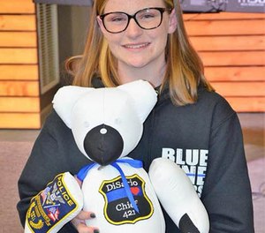 Megan O’Grady, 15, poses with one of the bears she made for a fallen officer's family. (Photo/Blue Line Bears)