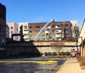 Firefighters continue efforts at an apartment building under construction.