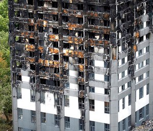 The burnt Grenfell Tower apartment building standing testament to the recent fire in London.