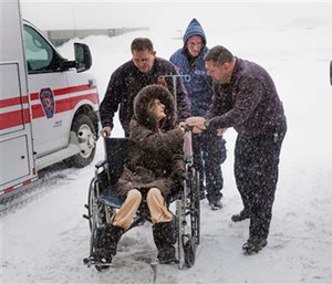 Paramedics wheel a patient into the hospital after driving through a blizzard to reach her. (Michael Beck/Stony Brook Hospital via AP)