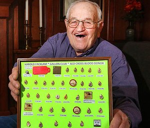 In a March 23, 2017 photo, Harold Facklam displays the many pins he has collected for having donated 32 gallons of blood over more than six decades, in Topeka, Kans. Facklam Jr.