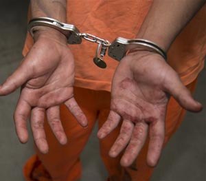In this Thursday, Jan. 30, 2014 photo from the Arizona Department of Corrections, Jacob Harvey is shown with the blood of his victim on his hands shortly after he is accused of attacking a state prison teacher in Florence, Ariz.