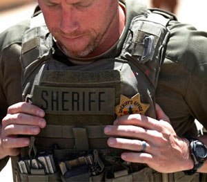 A member of the of the U.S. team puts on his body armor as he prepares to compete during the 6th annual Warrior Competition at King Abdullah Special Operations Training Center.
