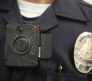 In this Jan. 15, 2014, file photo a Los Angeles Police officer wears an on-body camera during a demonstration in Los Angeles. (AP File Photo/Damian Dovarganes)