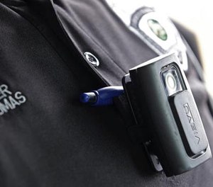 In this file photo taken on Tuesday, Sept. 29, 2015, a body camera is attached to the uniform of Whitestown Police Department officer Reggie Thomas during a traffic stop, in Whitestown, Ind. (AP Photo/Darron Cummings)