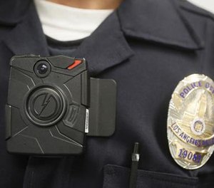 In this Jan. 15, 2014, file photo a Los Angeles Police officer wears an on-body camera during a demonstration in Los Angeles.
