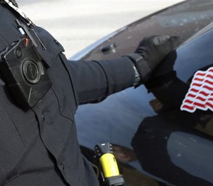 In this Feb. 2, 2015 file photo, a Duluth, Minn. officer has his body camera activated alongside a squad car.