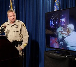 Las Vegas police Undersheriff Kevin McMahill watches body camera footage during a press conference on accusations by Seattle Seahawks player Michael Bennett, Wednesday, Sept. 6, 2017, in Las Vegas.