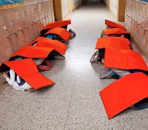 Students demonstrate how the Bodyguard blanket works.