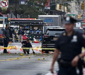 Crime scene investigators work Sunday, Sept. 18, 2016, at the scene of Saturday's explosion in Manhattan's Chelsea neighborhood, in New York. (AP Photo/Craig Ruttle)