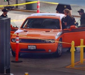 U.S. Customs and Border Protection investigators examine a car in the secondary inspection area at the San Ysidro, Calif., border crossing with Mexico, Tuesday, Aug. 12, 2014. (AP Image)