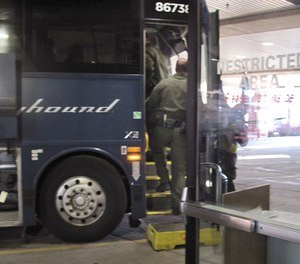 Agents for Customs and Border Protection board a Greyhound bus headed for Portland, Ore., at the Spokane Intermodal Center, a terminal for buses and Amtrak, in Spokane, Wash. (Photo/AP)
