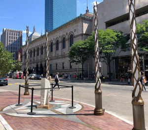 Light spires and one of the stone pillars stand along Boylston Street after installation was finished, Monday, Aug. 19, 2019, in Boston to memorialize the Boston Marathon bombing victims at the sites where they were killed.