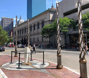 Light spires and one of the stone pillars stand along Boylston Street after installation was finished, Monday, Aug. 19, 2019, in Boston to memorialize the Boston Marathon bombing victims at the sites where they were killed.