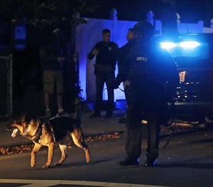 Police search for a suspect after a shooting in the East Boston neighborhood of Boston, Wednesday, Oct. 12, 2016. (AP Photo/Charles Krupa)