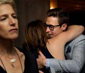 Boston Marathon bombing survivors Celeste Corcoran, center left, and Patrick Downes, center right, embrace as Ricki Stern, left, co-director of the film