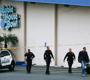 Torrance Police Department investigators walk towards waiting family members, as officers confirm fatalities in a shooting incident at the Gable House Bowl in Torrance, Calif., Saturday, Jan. 5, 2019. A brawl between two large groups at the popular Los Angeles-area bowling alley and karaoke bar erupted into gunfire early Saturday according to witnesses.