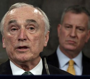 In this Jan. 12, 2016 file photo, New York City Police Commissioner William Bratton, left, speaks during a news conference in New York's City Hall, as New York Mayor Bill de Blasio listens.