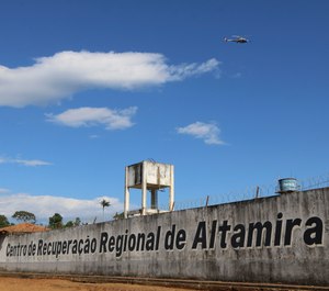 A police helicopter flies over the Regional Recovery Center, a prison, in Altamira, Para state, Brazil, Monday, July 29, 2019. (Wilson Soares/Panamazonica via AP)