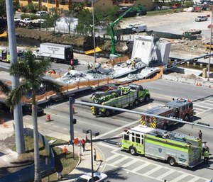 Several people were seen being loaded onto ambulances after at least five vehicles were trapped underneath the newly-installed bridge.