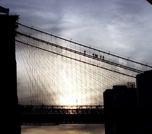 New York City Police Department Emergency Service personnel remove an attempted suicide victim from the Brooklyn Bridge, Wednesday, Nov. 25, 1998. (AP Photo/Steve Spak)