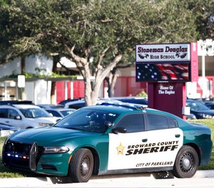 A Broward County Sheriff's Office vehicle is parked outside Marjory Stoneman Douglas High School, Wednesday, Aug. 15, 2018, in Parkland, Fla. (AP Photo/Wilfredo Lee)