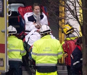 A woman is evacuated in an ambulance by emergency services after a explosion in a main metro station in Brussels.