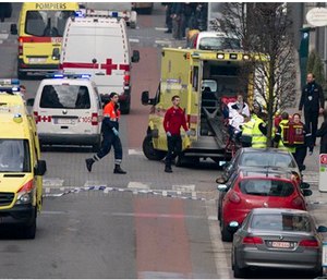 A woman is evacuated in an ambulance by emergency services after a explosion in a main metro station in Brussels. (AP Photo/Virginia Mayo)