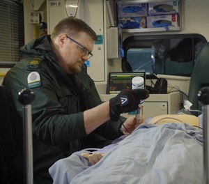 A robotic glove worn by a paramedic allowed a doctor to remotely perform an ultrasound scan on a mannequin representing a patient during a demonstration by the University Hospitals Birmingham and telecommunications company BT.