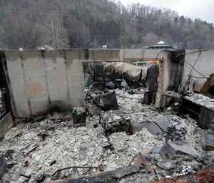 Some walls of a burned-out business remain after a wildfire swept through the area Monday.
