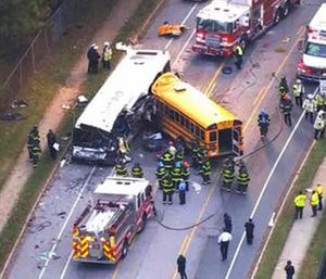 Emergency personnel work at the scene of a fatal school bus and a commuter bus crash in Baltimore.