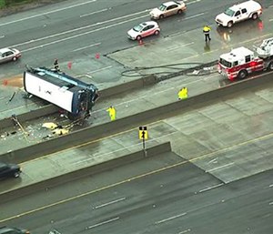 The bus flipped on its side while traveling north on Highway 101, California. (KGO-TV via AP)