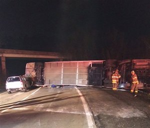 Authorities work the scene where a charter bus carrying college students to three Virginia campuses overturned.