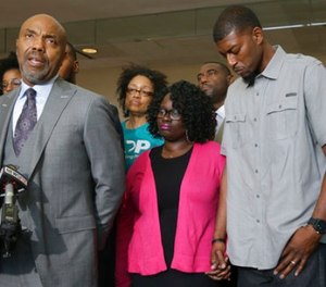 Attorney Daryl Washington, left, speaks on behalf of Jordan Edwards' parents, Charmaine Edwards, center and Odell Edwards during a news in Dallas, Thursday, May 11, 2017. (AP Photo/LM Otero)