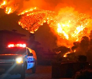 Fire burns canyons and ridges above Bella Vista Drive near Romero Canyon as the fight to contain a wildfire continues in Montecito, Calif.