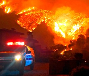 Fire burns canyons and ridges above Bella Vista Drive near Romero Canyon as the fight to contain a wildfire continues in Montecito, Calif. (Mike Eliason/Santa Barbara County Fire Department via AP)